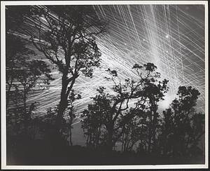 Ack-ack tracer fire was sent up by marines units to form this pattern against the blackness of a South Pacific sky