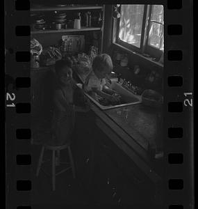 Children playing in kitchen sink