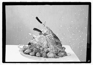 Carving knife and fork in cooked turkey