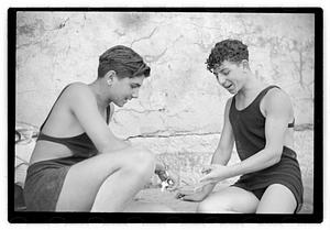 Two unidentified young men playing rock scissor paper