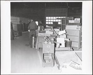 Interior of file cabinets and 3 employees