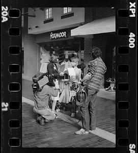 Market researcher interviews customers at shopping mall in Brighton