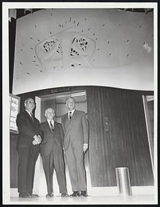 Dedicate Bas-Relief--Noted sculptor George Aarons, center, of Gloucester and Brookline, stands under his 16-foot bas-relief on foyer of Combined Jewish Philanthropies facility, 72 Franklin St. Left, Sidney Stoneman, Back Bay, CJP president; right, Norman L. Cahners, Brookline, co-chairman, 70th anniversary committee.