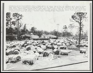 Huge rolls of paper bound for an unknown port nearly cover what once was a recreation area here 8/18 in the wake of hurricane Camille. The paper, along with other cargo, were thrown from a ship more than a mile away by the force of the winds and water, leveling a large pavilion in the center and smashing several homes flat. It looked like a large-scale bowling alley.