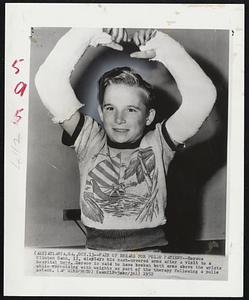 Pair of Breaks for Polio Patient--Horace Clinton Gann, 12, displays his cast-covered arms after a visit to a hospital here. Horace is said to have broken both arms above the wrists while exercising with weights as part of the therapy following a polio attack.