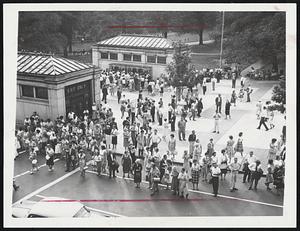 Tremont Street Scene – This was typical of the crowds of commuters or waited in one spot, who were stranded by the MTA strike and wandered around seamlessly, hoping to find some means of transportation. The crowd congregates on the mall and on Tremont street, near the park street station. In the background, are lines of commuters outside even telephone booths.