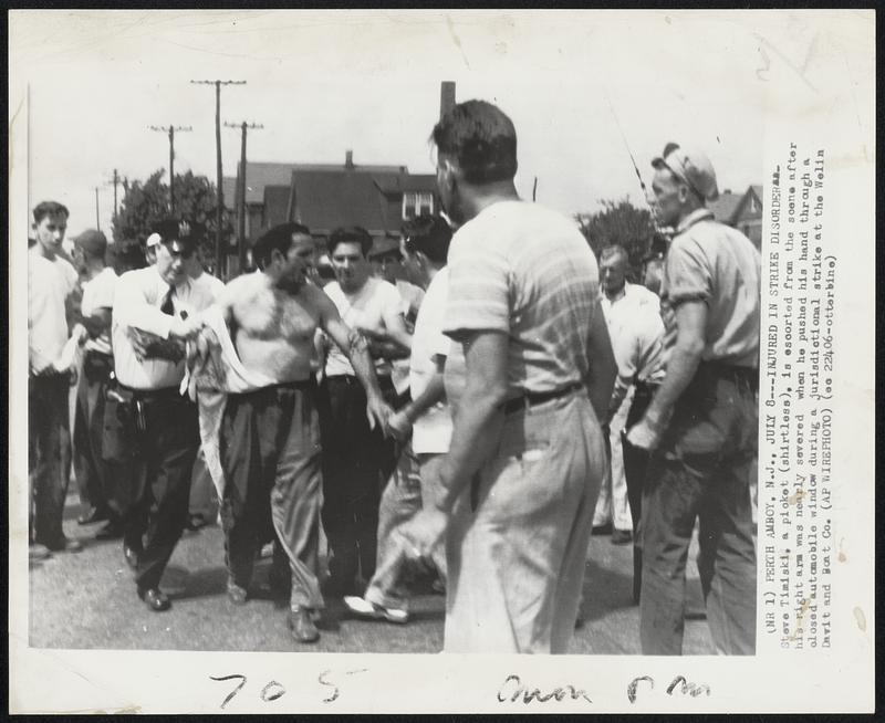 Injured in Strike Disorder- Steve Timiski, a picket (shirtless). is escorted from the scene after his right arm was nearly severed when he pushes his hand through a closed automobile window during a jurisdictional strike at the Welin Davit and Boat Co.