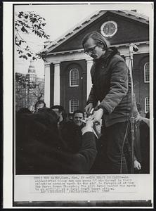 Too Heavy To Carry-An unidentified young man was among 18 who turned in their selective service cards to the girl in foreground at the New Haven Green Thursday. The girl later handed the cards to an official at the local draft board office.