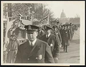 Parades On Pennsylvania Avenue. Part of the parade of 3,000 so-called "Hunger-Marchers" up Pennsylvania avenue, Washington, D.C., Dec. 6, when they went to present their petition for unemployment relief to speaker John N. Garner. Although there was no disorder, the paraders were heavily guarded.