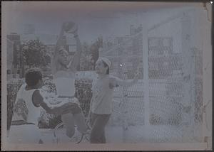 Tico Garcia (left) plays basketball with his twin, Daco Garcia, while Rainier Rosado looks on