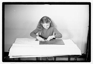 A girl matching fitting shapes in a puzzle