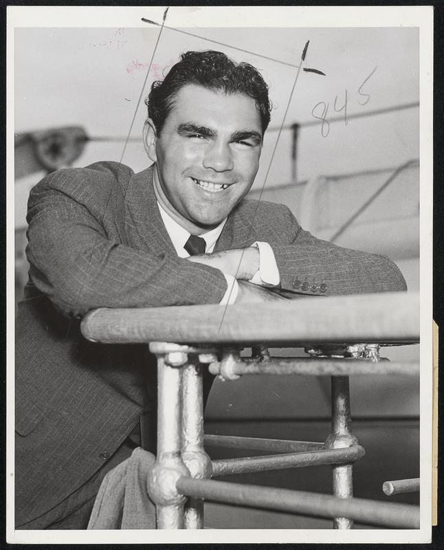 Here To See Championship Fight New York City - Max Schmeling, former heavyweight boxing champion of the world, pictured on board the North German Lloyd liner Bremen August 18 upon his arrival here from abroad. He is here to attend the bout between Joe Louis, present heavyweight champion of the world, and Tommy Farr, British champion, at Yankee Stadium August 26. After seeing the fight he intends to go hunting in Canada.