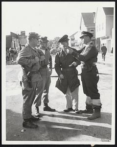 Airmen Aid Wareham -- Emergency guards from Otis Air Force Base joined National Guardsmen and State Police in Wareham patrols. Left to right, William Caruthers, Stewart Holden and Lt. L. Kornber getting directions from Wareham Officer Ray Pozzoli.