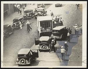 A view of the melee in Minneapolis that caused injuries to 68 persons. The clash between truck strikers and police came as officers sought to guide a convoy of foodstuffs past pickets. This excellent action scene shows police with tear and riot guns in close contact with the demonstrators.