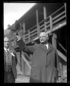 A man doffing his hat