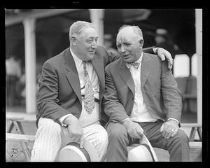 Two unidentified men seated in conversation