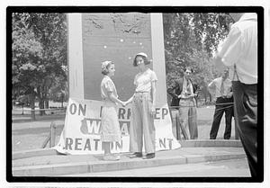 Two girls shaking hands in front of Declaration of Independence Tablet, Boston Common