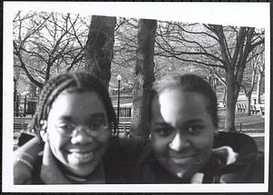 Two young women smiling in the park