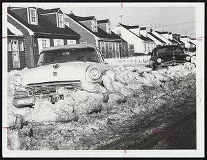 Six Days after the big snow storm and flood this car is blocked by big chunks of ice in the Kenberma section of Hull.