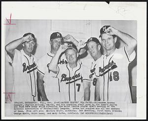 Milwaukee Braves manager, Charlie Dressen, center, and his coaching staff pose in the team's shirt and caps here today while attending the major league player draft meeting of the National Association of Professional Leagues. Dress and coaches are all new members of team. From left are: Whitlow Wyatt, pitching; Bob Sheffing, first base; Dressen; George Myatt, third base; and Andy Pafko, outfield.