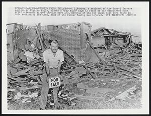 Robert L. Parker, a resident of the Sunset Terrace section of Wichita Falls, places a "for sale" sign in front of his demolished home after a tornado ripped through here 4/3. Several of the six known dead were found in this section of the town. None of the Parker family was injured.