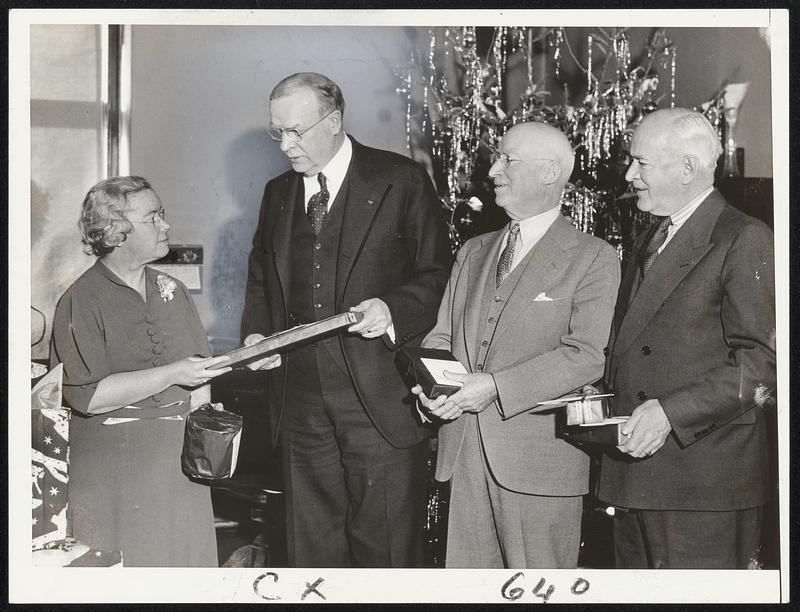 Mayor Mansfield receives present at Health Dept. Xmans party. Left to right Helen B. O'Donnell, Mayor Mansfield, Dr. William B. Keeler, Health Commissioner, and Joseph Mellyn, mayor's secretary.