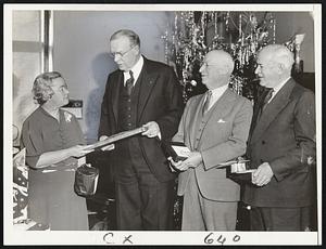 Mayor Mansfield receives present at Health Dept. Xmans party. Left to right Helen B. O'Donnell, Mayor Mansfield, Dr. William B. Keeler, Health Commissioner, and Joseph Mellyn, mayor's secretary.