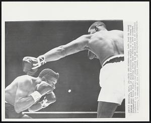 This one Missed-- Long left lead by Sonny Liston goes past head of Floyd Patterson tonight in first round of heavyweight title fight. Shortly after this action a left pounded Patterson to the canvas--and eventually he was kayoed in an official 2 minutes, 6 seconds of the first round.