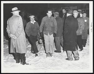 Two pass through picket line at the East Boston tunnel site. Most of the workers reported for work early to avoid the pickets, who are protesting hiring practices at the construction project. About 25 carpenters honored the picket line.