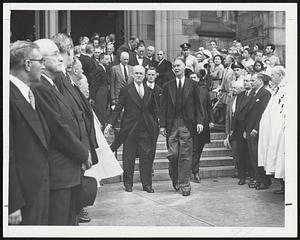Former President Harry S. Truman, standing, hat in hand, at left, gazes solemnly ahead as a group of mourners, led by Gov. Herter, file from the Cathedral of the Holy Cross following Solemn Pontifical HIgh Mass of Requiem yesterday for Maurice J. Tobin.