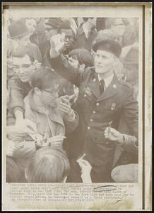 Draft Card Burner-- Man wearing uniform and green beret burns draft card today during peace demonstration in Central Park in New York City. The man, identified as Gary Rader of Evanston, Ill., said his bus fare to New York City has been paid for by student organization. He described himself as a "paid performer."