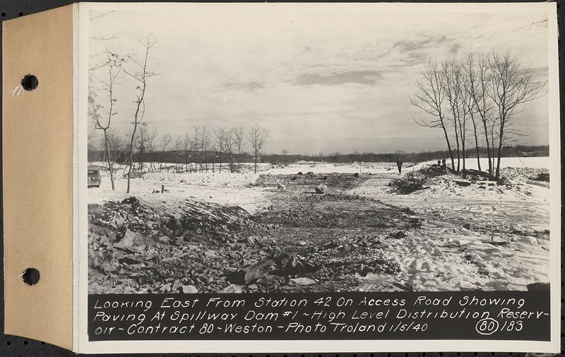 Contract No. 80, High Level Distribution Reservoir, Weston, looking east from Sta. 42 on access road showing paving at spillway dam 1, high level distribution reservoir, Weston, Mass., Jan. 5, 1940