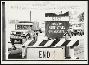 Is It The End?--Ohio National Guardsmen that were called in to quell students, that resulted in a melee Monday with four students killed, leave the Kent State University campus. Here, the last of a contingent of less than 300 who stayed Thursday night rolls out of town at noon Friday past the city limits sign and one that says "End construction"