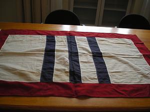 Banner with white ground centering three blue stripes