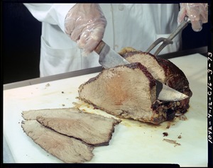 Top round beef roast being sliced