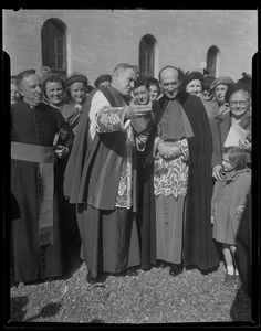 Rev. Cushing and another clergyman standing with a crowd in front of a church