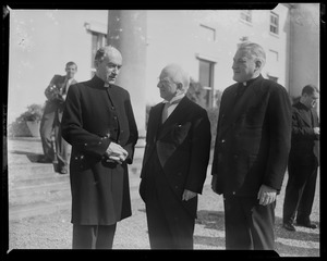 A man standing with an unidentified clergyman and Rev. Cushing