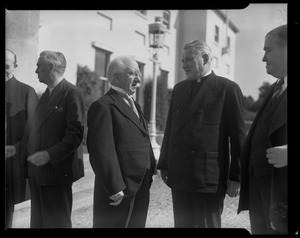 Men speaking with Rev. Cushing and Gov. Paul Dever