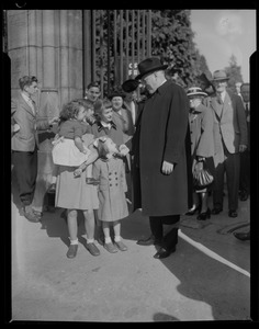 Group of children talking to Rev. Cushing