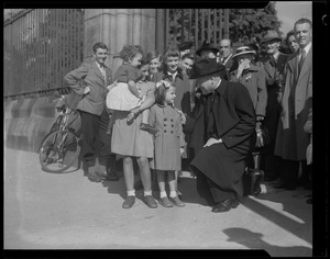 Group of children talking to Rev. Cushing