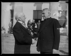 Man speaking with Rev. Cushing