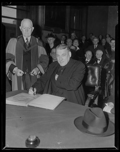 Rev. Cushing signing the book prior to receiving the Freedom of the City