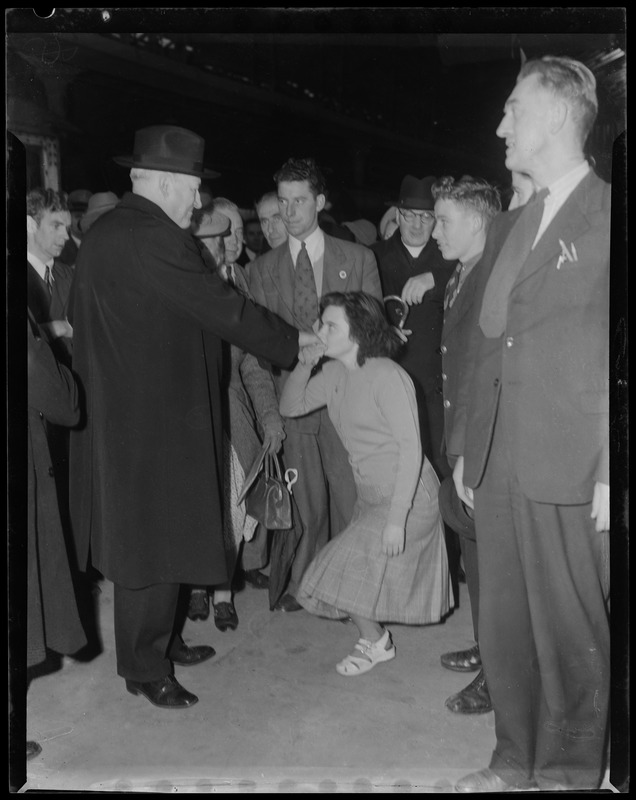 Girl kissing hand of Rev. Cushing