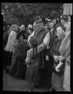 Rev. Cushing stands with a crowd of adults and children