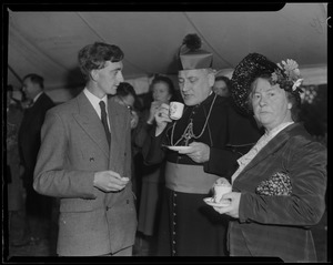 Rev. Cushing having tea with an unidentified man and woman