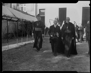 Rev. Cushing walking with another member of the clergy and an unidentified man