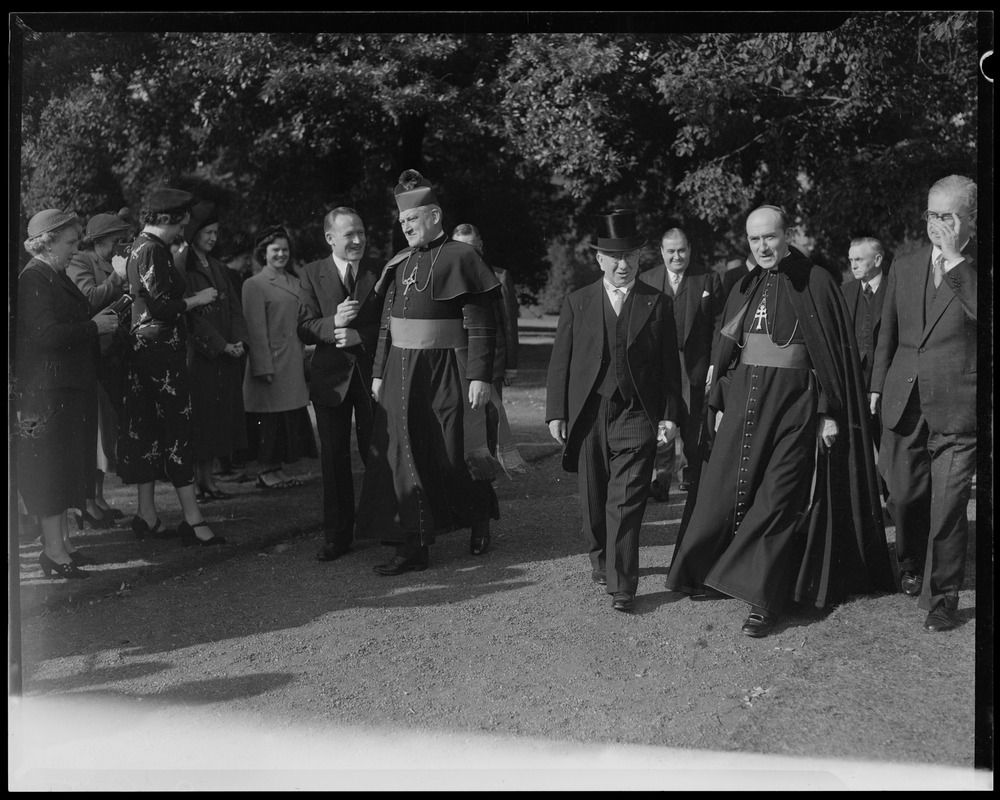 Rev. Cushing walking with other men and members of the clergy