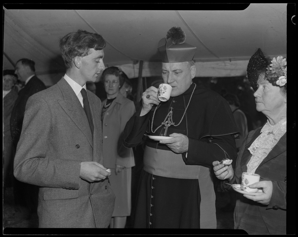 Rev. Cushing having tea with an unidentified man and woman