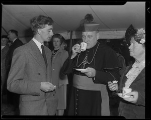 Rev. Cushing having tea with an unidentified man and woman