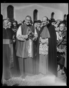 Rev. Cushing standing with another member of the clergy in front of a crowd